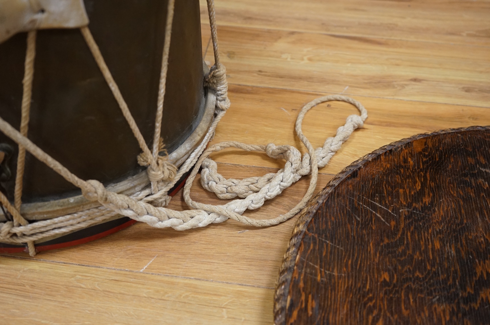 A late 19th/early 20th century Royal East Kent Regiment 'Buffs' regimental drum, 37cm diameter, 37cm high, together with a rope edged, stained pine removable 'table top' adaption